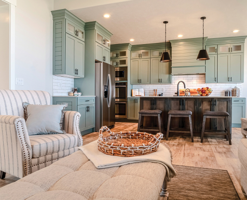 Kitchen viewed from the living room of home with upholstered table and armchairs